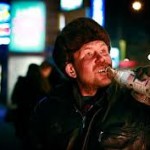 man on street with drink